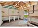 Shed interior with exposed rafters and multiple wood countertops at 12918 Cambridge Ave, Tampa, FL 33624