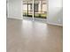Living room with tile floors and glass sliding doors to the outdoor patio at 18491 Green Garden Ct, Venice, FL 34293