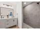 Modern bathroom featuring double vanity, tiled shower, and contemporary finishes at 2181 Wateroak N Dr, Clearwater, FL 33764
