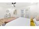 Bright bedroom with neutral tones, ceiling fan, and French doors at 2181 Wateroak N Dr, Clearwater, FL 33764
