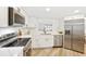 Bright kitchen featuring white cabinets, stainless steel appliances, and modern countertops at 2181 Wateroak N Dr, Clearwater, FL 33764