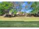 Expansive backyard with lush lawn and mature trees creating a private and serene outdoor space at 310 Summer Clouds Pl, Brandon, FL 33511