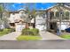 Townhouse-style condominiums showcase attached garages, arched entryways and well-maintained landscaping at 310 Summer Clouds Pl, Brandon, FL 33511