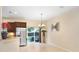 Eat-in kitchen boasts stainless steel appliances, wood cabinets, and backyard view at 310 Summer Clouds Pl, Brandon, FL 33511