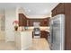 Well-equipped kitchen with stainless appliances, wood cabinetry, and tile flooring at 310 Summer Clouds Pl, Brandon, FL 33511