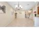 Open-concept living space boasts tile flooring, modern chandelier, and neutral color palette at 310 Summer Clouds Pl, Brandon, FL 33511