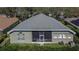 The backyard features a screened lanai with patio furniture, a lawn, and well-maintained landscaping at 3110 Bent Creek Dr, Valrico, FL 33596