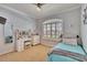 Bright bedroom with large window, neutral walls, vanity and modern decor at 3110 Bent Creek Dr, Valrico, FL 33596