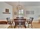 Elegant dining room features a wood table, rustic chairs, unique chandelier, and plantation shutters at 3110 Bent Creek Dr, Valrico, FL 33596