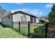 This is the exterior of the home with a well-maintained lawn, a black fence, and lush landscaping at 3110 Bent Creek Dr, Valrico, FL 33596
