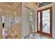 Elegant foyer with tile flooring, decorative glass front door and views to other rooms at 3110 Bent Creek Dr, Valrico, FL 33596