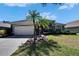 Charming home with a two-car garage, landscaped yard, and lush green lawn at 3110 Bent Creek Dr, Valrico, FL 33596