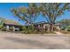 The golf shop entrance boasts lush landscaping, stone pillars, and covered walkway at 3110 Bent Creek Dr, Valrico, FL 33596