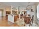 Open concept kitchen and dining area featuring granite counters, stainless appliances, and a stylish chandelier at 3110 Bent Creek Dr, Valrico, FL 33596