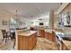 Open kitchen and living area featuring granite countertops, stainless steel appliances, and spacious dining table at 3110 Bent Creek Dr, Valrico, FL 33596