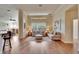 Open living room with hardwood floors, neutral decor, and views to other rooms at 3110 Bent Creek Dr, Valrico, FL 33596