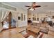 Open-concept living room with wood floors, French doors, and seamless flow to kitchen at 3110 Bent Creek Dr, Valrico, FL 33596