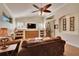 Comfortable living room featuring vaulted ceilings, wood floors, built-in shelving, and lots of natural light at 3110 Bent Creek Dr, Valrico, FL 33596