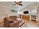 Inviting living room featuring hardwood floors, built-in shelves and a large window at 3110 Bent Creek Dr, Valrico, FL 33596