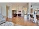 Bright living room featuring hardwood floors, elegant decor, and seamless flow to kitchen and dining area at 3110 Bent Creek Dr, Valrico, FL 33596