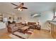Cozy living room with hardwood floors, open layout, ceiling fan, and ample natural light at 3110 Bent Creek Dr, Valrico, FL 33596