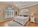 Bright main bedroom with a window, white shutters, plush carpet, and high ceilings at 3110 Bent Creek Dr, Valrico, FL 33596