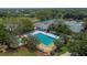 Stunning community pool with mature landscaping, lounge seating, and adjacent tennis courts at 3110 Bent Creek Dr, Valrico, FL 33596