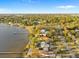 Aerial view of a waterfront home with lush trees, private dock, and a tranquil bay setting at 316 Shore E Dr, Oldsmar, FL 34677