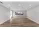 Spacious basement featuring wood floors, recessed lighting, and a neutral color scheme at 316 Shore E Dr, Oldsmar, FL 34677