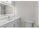 Modern bathroom with marble countertop vanity, illuminated mirror, and contemporary fixtures at 316 Shore E Dr, Oldsmar, FL 34677