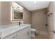 Modern bathroom featuring a white vanity, sleek mirror, and tiled walk-in shower at 316 Shore E Dr, Oldsmar, FL 34677