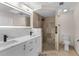 Modern bathroom with double sinks, marble countertops, and a walk-in shower at 316 Shore E Dr, Oldsmar, FL 34677