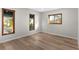 Sunlit bedroom featuring multiple windows and wood flooring throughout at 316 Shore E Dr, Oldsmar, FL 34677