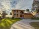 Elegant home with lush lawn and curved driveway showcasing curb appeal and classic architecture at 316 Shore E Dr, Oldsmar, FL 34677