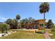 A charming two-story home featuring a pool, beautiful landscaping, and a tranquil outdoor space at 316 Shore E Dr, Oldsmar, FL 34677