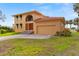 Spacious two-story home with a red tile roof and attached two-car garage at 316 Shore E Dr, Oldsmar, FL 34677