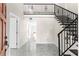 Bright foyer showcases marble floors, a staircase with metal railings, and an open layout at 316 Shore E Dr, Oldsmar, FL 34677