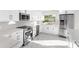 Modern kitchen features white cabinets, stainless steel appliances and marble countertops at 316 Shore E Dr, Oldsmar, FL 34677