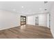 Bright living room with wood floors, recessed lighting, and sliding glass doors to the outside at 316 Shore E Dr, Oldsmar, FL 34677