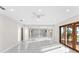 Spacious room featuring marble flooring, recessed lighting, and sliding doors leading to outdoor space at 316 Shore E Dr, Oldsmar, FL 34677