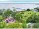 Aerial view of a park featuring a playground, walking paths, a pier, and open green space at 316 Shore E Dr, Oldsmar, FL 34677