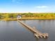 Aerial view of a long pier with a covered gazebo extending into the water at 316 Shore E Dr, Oldsmar, FL 34677