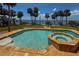 Backyard pool featuring tile accents, a spa, and beautiful water views at 316 Shore E Dr, Oldsmar, FL 34677