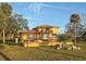 View of two-story home featuring a covered patio and well-manicured landscaping at 316 Shore E Dr, Oldsmar, FL 34677
