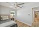 This bedroom features a ceiling fan, wood flooring, and lots of natural light at 4004 W Coachman Ave, Tampa, FL 33611