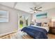 Sun-lit bedroom with French doors opening to the backyard and light wood floors at 6142 4Th S Ave, St Petersburg, FL 33707