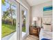 Bedroom with door leading to back yard and view of the backyard through the door at 6142 4Th S Ave, St Petersburg, FL 33707