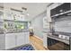 Well-lit open concept kitchen featuring granite countertops, stainless steel appliances, and wood floors at 6142 4Th S Ave, St Petersburg, FL 33707