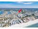 Aerial view of waterfront condos with boat docks, conveniently located near the beach, bridge, and waterfront amenities at 657 Garland Cir, Indian Rocks Beach, FL 33785