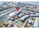Amazing aerial view showcases waterfront condos with boat docks and community amenities, including a pool and tennis court at 657 Garland Cir, Indian Rocks Beach, FL 33785